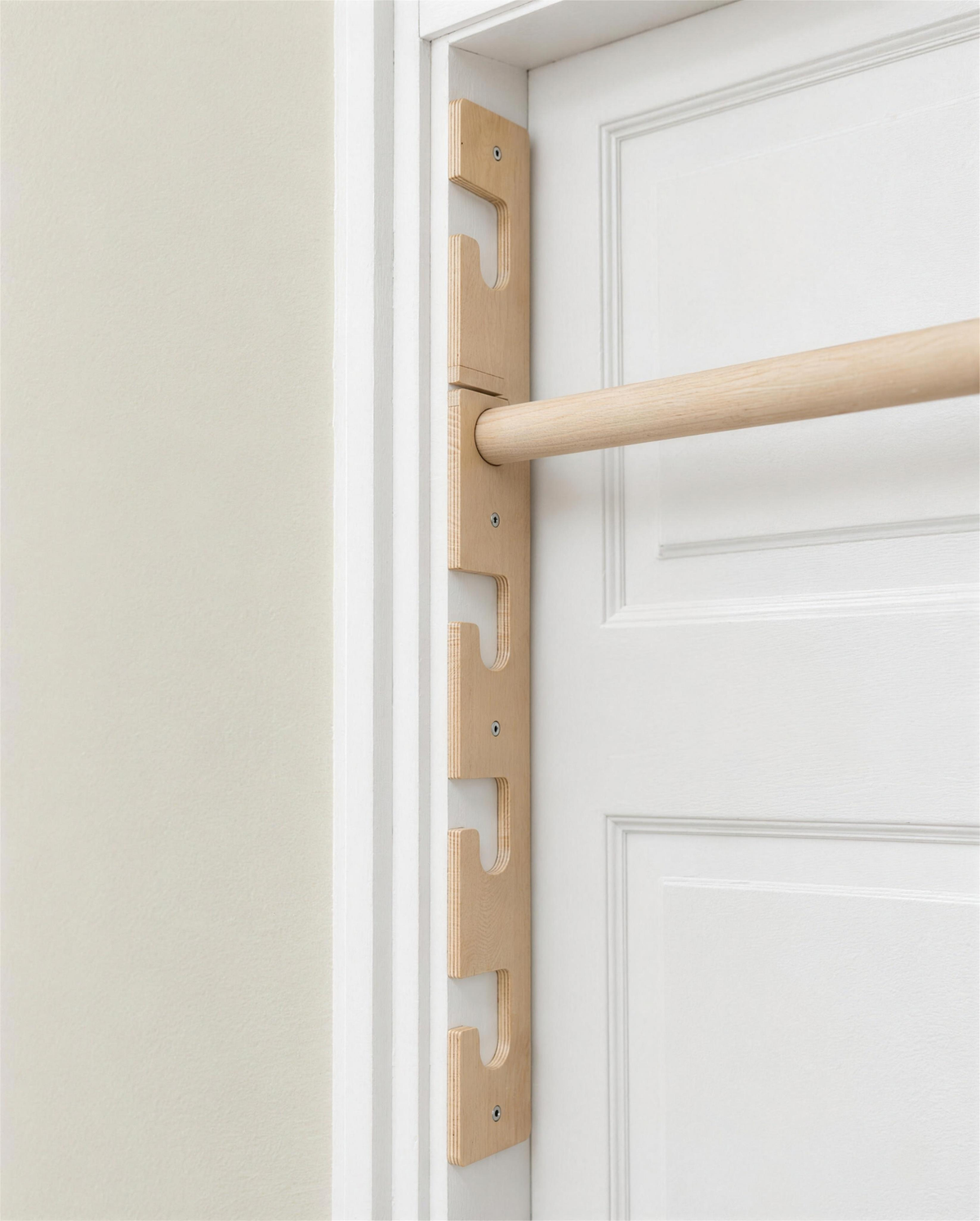 Close-up of a birch plywood side support on the door jamb showing the round bar seats, plywood edge and locking piece