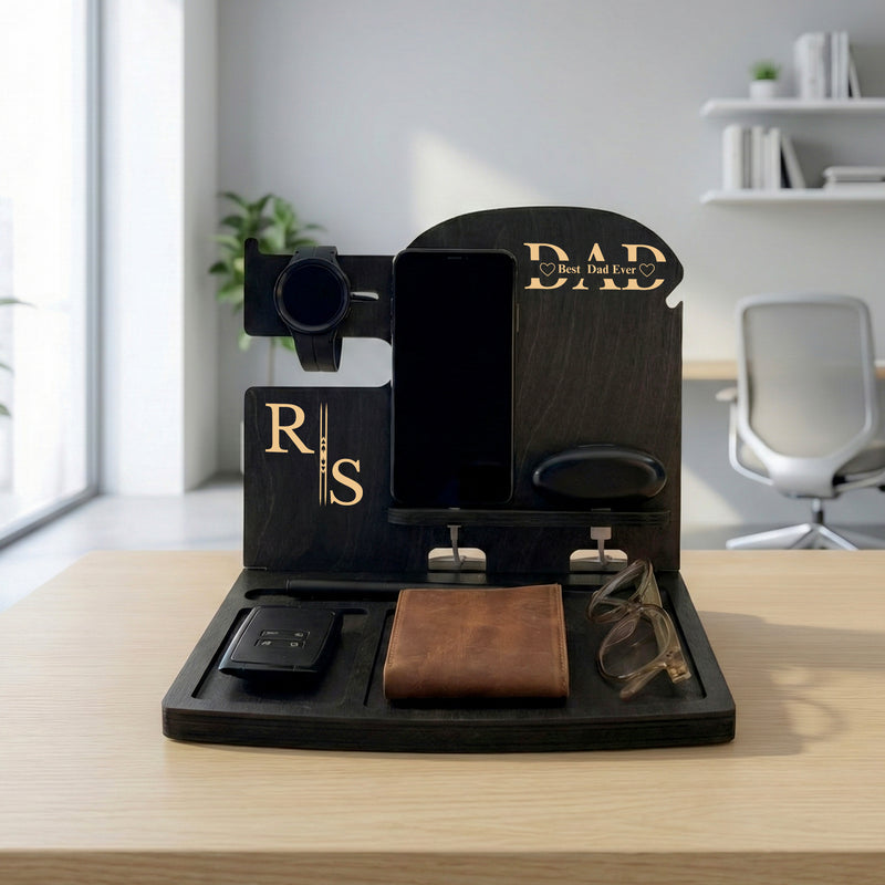 Black birch plywood docking station with initials and Dad engraving, holding a phone, watch, wallet and keys