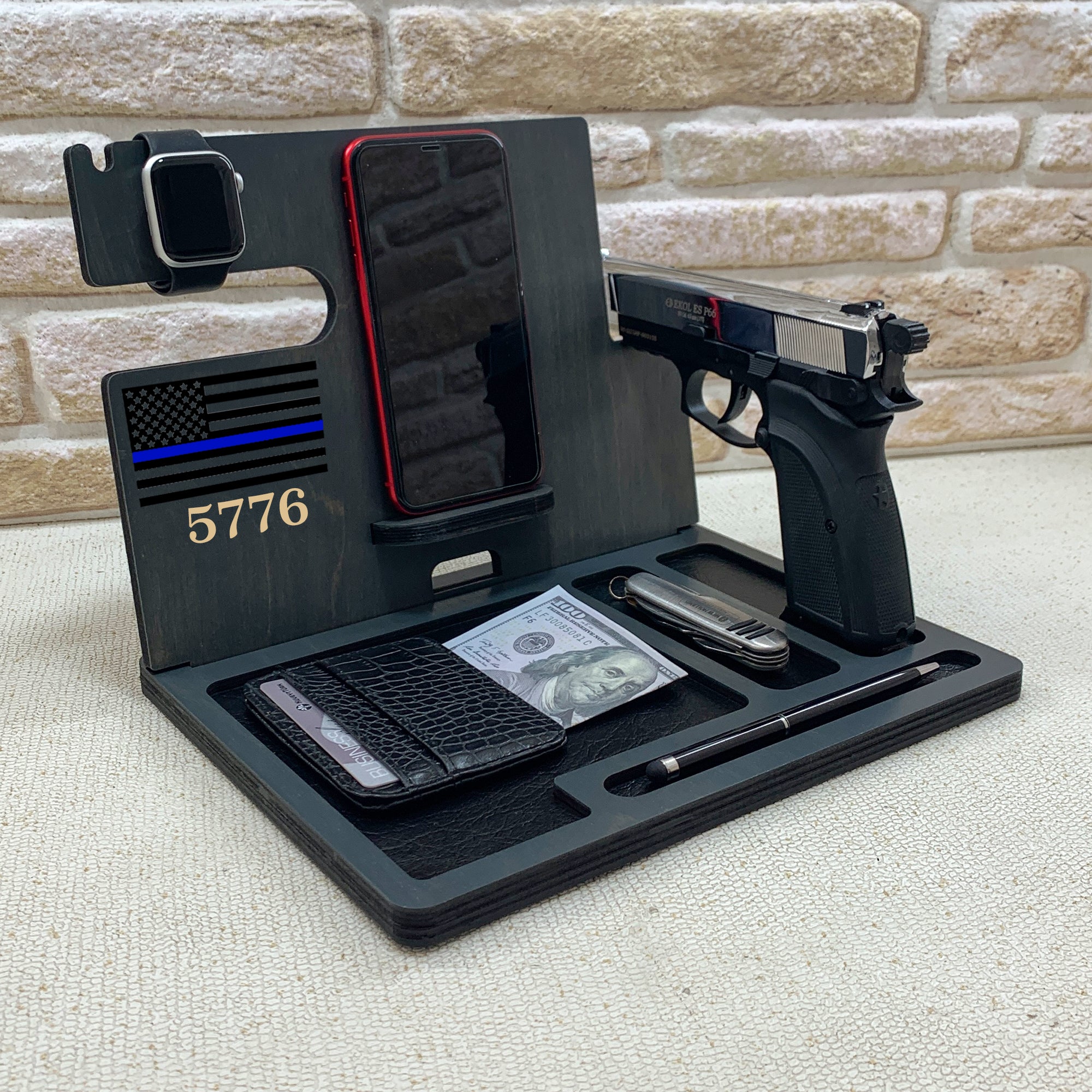 Personalized wooden nightstand valet with custom engraved with name. Personalized gifts for police officer which include holders for an Apple Watch, smartphone, wallet, pen, and a dedicated slot for a handgun. The stand is organized to keep everyday carry items neatly in place. ideal gifts for law enforcement, police retirement and the one who have gun. 