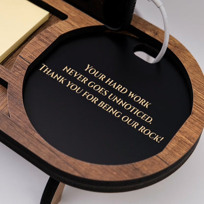 Close-up of a brown desk organizer tray engraved with an employee thank-you message